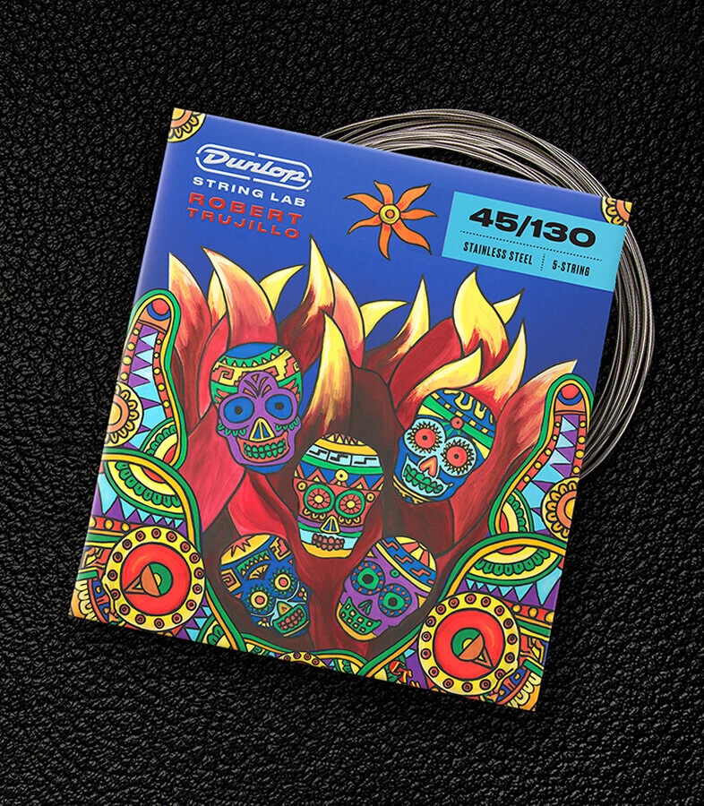A Dunlop bass string package with the coiled strings fanned out beside it.
