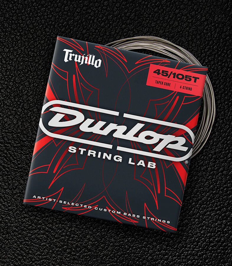 A Dunlop bass string package with the coiled strings fanned out beside it.