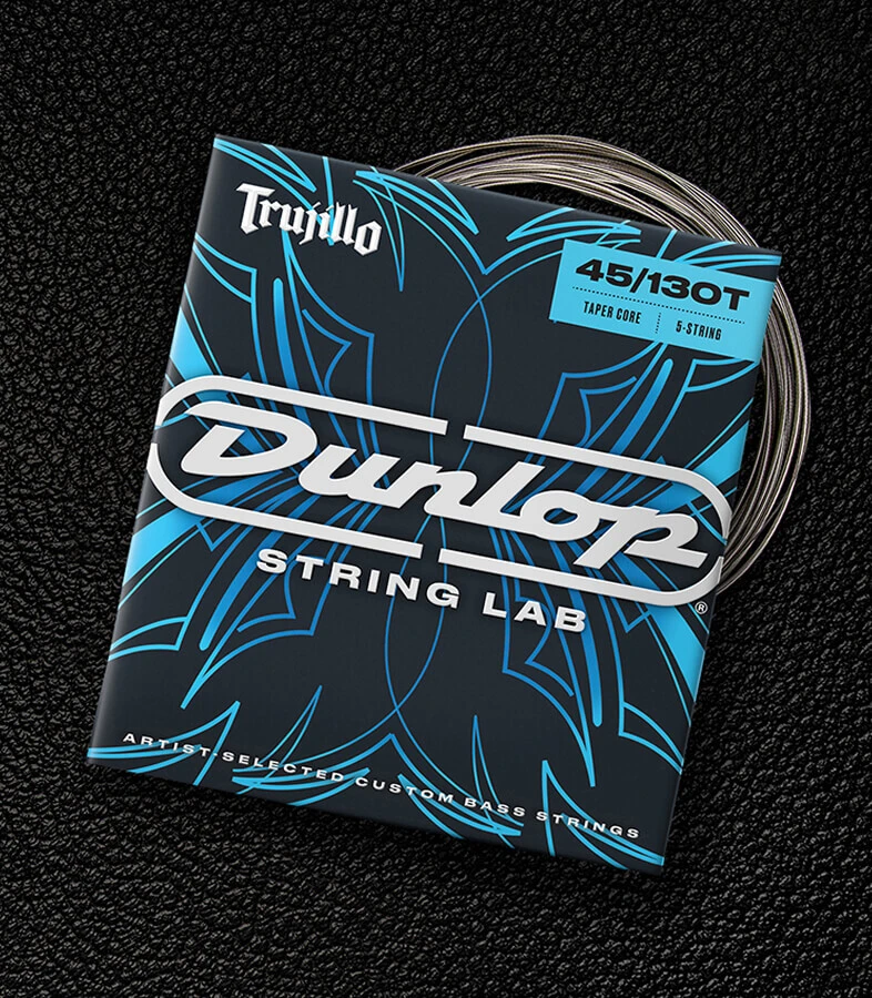 A Dunlop bass string package with the coiled strings fanned out beside it.