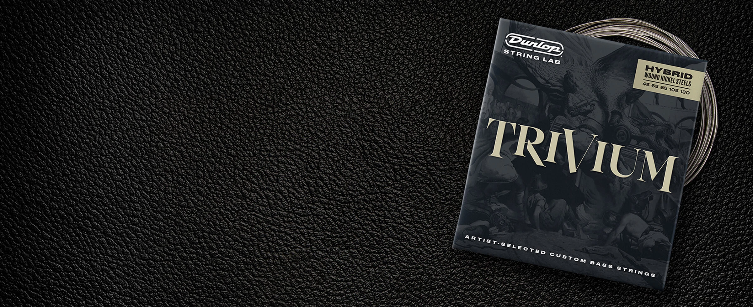 A Dunlop bass string package with the coiled strings fanned out beside it.