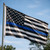 Black and white American flag with single blue stripe displayed outdoors