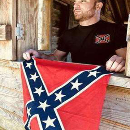 Close-up of Confederate flag graphic printed on men’s T-shirt, showing fabric texture and stitching detail.