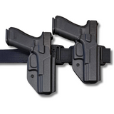 Two black Low Rider OWB holsters with pistols inserted, mounted side-by-side on a black tactical belt. Showing the 2 differnt ride heights.