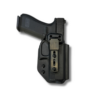Black Kydex IWB holster with Ulticlip attachment, mounted on a Glock 45 pistol.