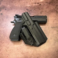 Black Skinny Guy holster with CZ P-01 pistol on brown textured surface Black Skinny Guy holster with CZ P-01 pistol on brown textured surface