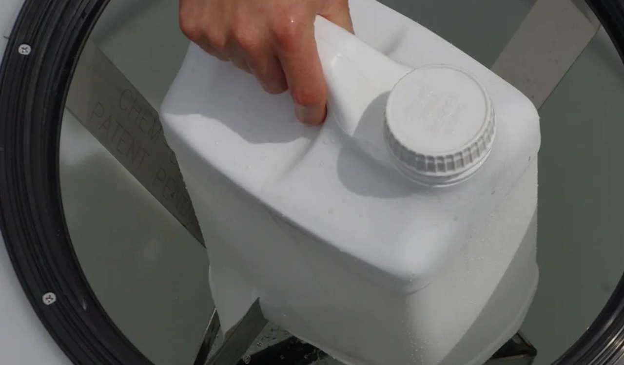 Chemical being put in Chem-Blade 2-1/2 Gallon Jug Opener and Rinser