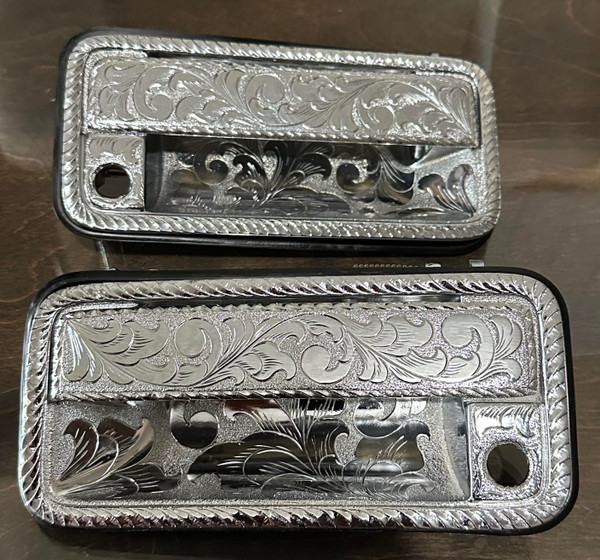 Pair of Billet Aluminum Hand Engraved Door Handles.<br>
Fits 1988-1998 GMC & Chevy Trucks/SUV’s <br>
Each piece is hand engraved and has a unique design variation.<br>
No two pieces are the exactly alike.<br>