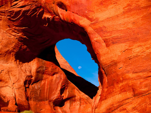 Photograph of the  Moon framed within the Ear Of The Wind Arch Monument Valley  Arizona