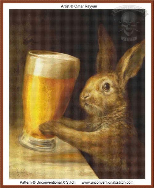 cross stitch pattern of a rabbit holding a tall glass of beer