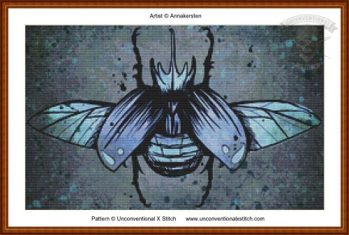 Cross-stitch pattern of an artistic depiction of a beetle-like insect with its wings spread open. The insect is centrally positioned against a textured backg