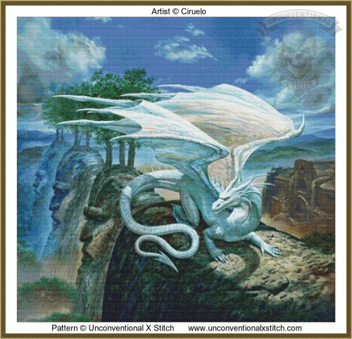 cross stitch pattern of a dragon with blue-white scales and large wings sits on a cliff with carved faces and trees, against a sky with clouds