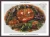 A fall themed cross stitch pattern of a Jack-o lanterm with spooky carved eyes in a rich autumn green. Surrounded by corn and grapes and other fruits and vegetables in a stylised illustration. 
