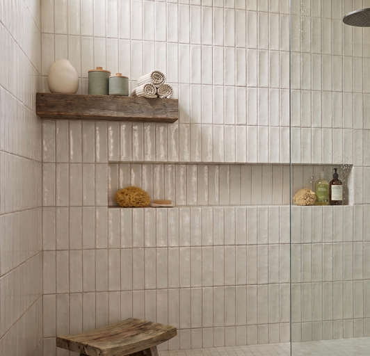 Modern organic shower faturing Marrakech total white subway tile in a vertical stacked pattern