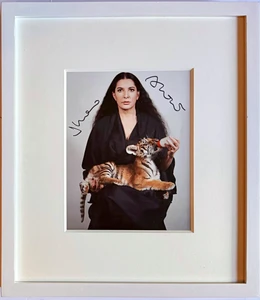 Marina Abramovic - hand signed photograph of the artist feeding a baby tiger, 2012