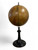 Antique terrestrial globe of the world on wooden turned stand modern reproduction side view