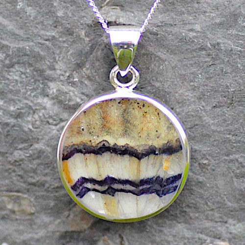 Hand carved sterling silver and Derbyshire blue john circular solid backed pendant