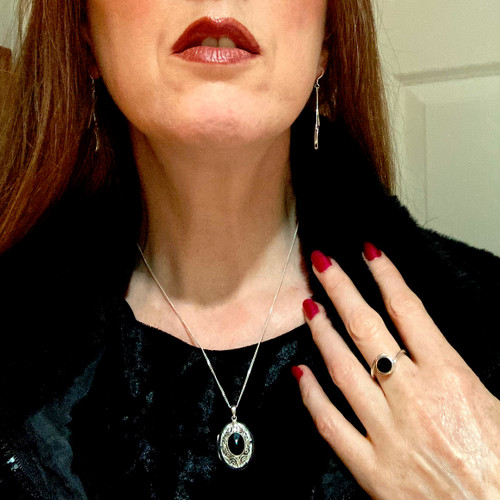 Large ornate oval sterling silver locket with hand carved Whitby Jet