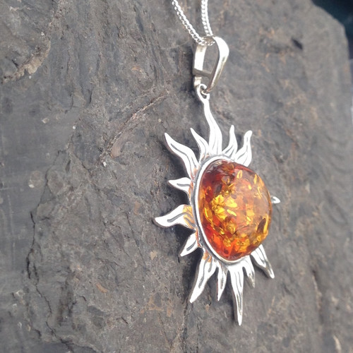 Large sterling silver solar pendant with shiny cognac amber cabochon