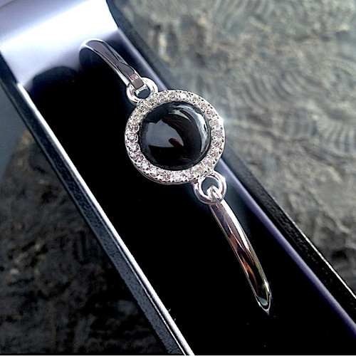Sterling silver bangle with round Whitby Jet stone within a frame of cubic zirconia