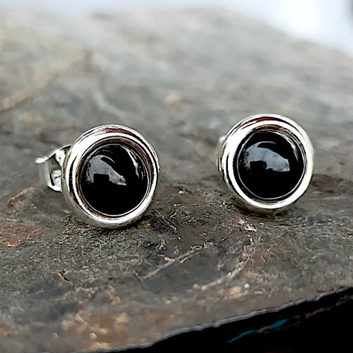 Modern round sterling silver stud earrings with Whitby Jet cabochons and a wide silver edge