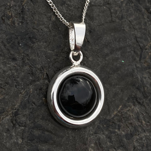 Hand crafted 925 silver circular pendant with organic black gemstone