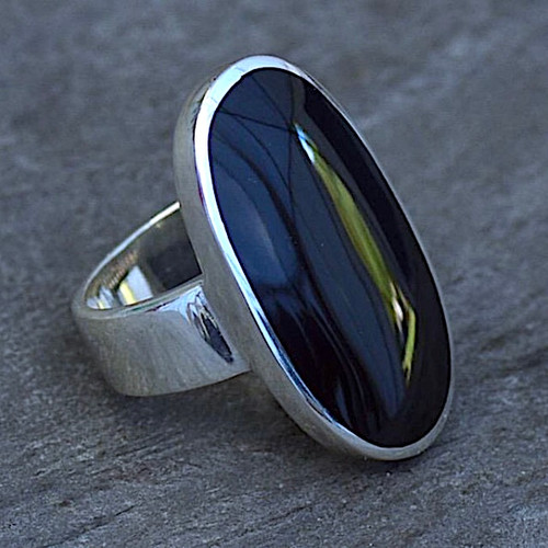 Hand crafted 925 silver band set with large oval black organic shiny stone