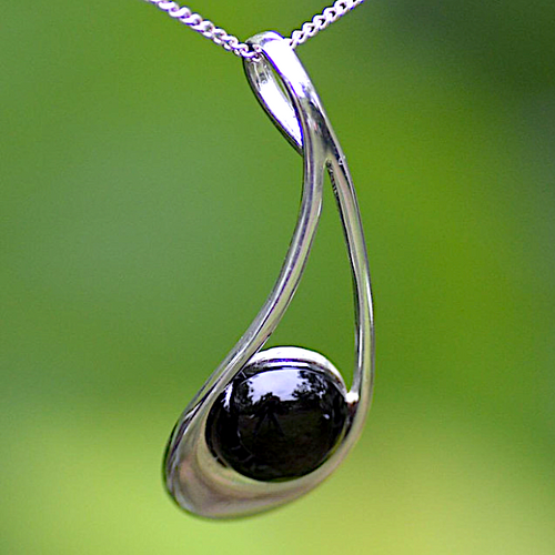 Curved open sterling silver and Whitby Jet modern oval cabochon pendant