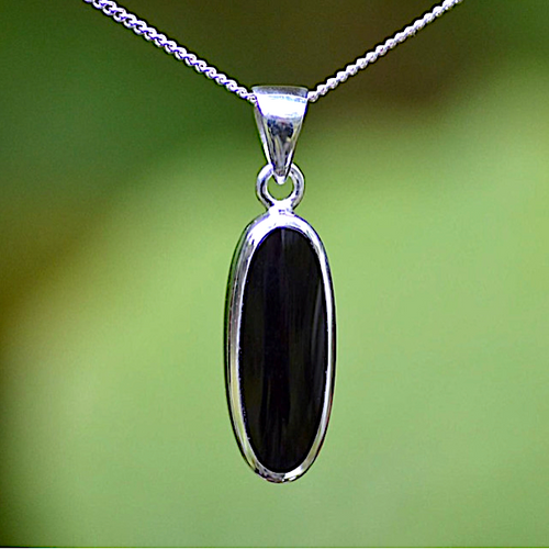 Hand crafted elongated oval Whitby Jet pendant with solid silver reverse