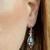 Sterling silver filigree dangly earrings with hand carved blue turquoise teardrop stone