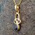 Small 9ct gold Celtic loop pendant with oval Whitby Jet stone