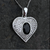 Sparkly sterling silver heart pendant with oval organic shiny black gemstone