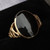 Ladies 9 carat gold fancy ring with hand cut shiny oval Whitby Jet stone