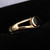 Classic gold split ring with circular organic black gemstone