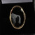 Handmade 18 carat gold statement ring with wide curved shoulder and oval Jet stone