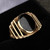 Gents 18ct yellow gold and Whitby Jet oval open ribbed shoulder ring with gift box