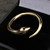 Mens gold open snake ring with organic black gemstone eyes