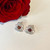 Hand crafted sterling silver rose stud earrings with red garnet cabochons