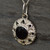 Round sterling silver flower pendant with Whitby Jet