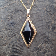 Hand crafted Whitby Jet and 9ct gold diamond shaped pendant on gold curb chain