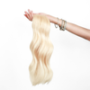 Holding Lightest Blonde Classic Clip In Hair Extensions Cashmere Hair