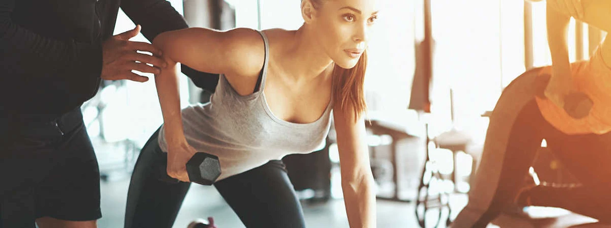 Personal Trainer Teaching Client Strength Training Personal Trainer Teaching Client Strength Training