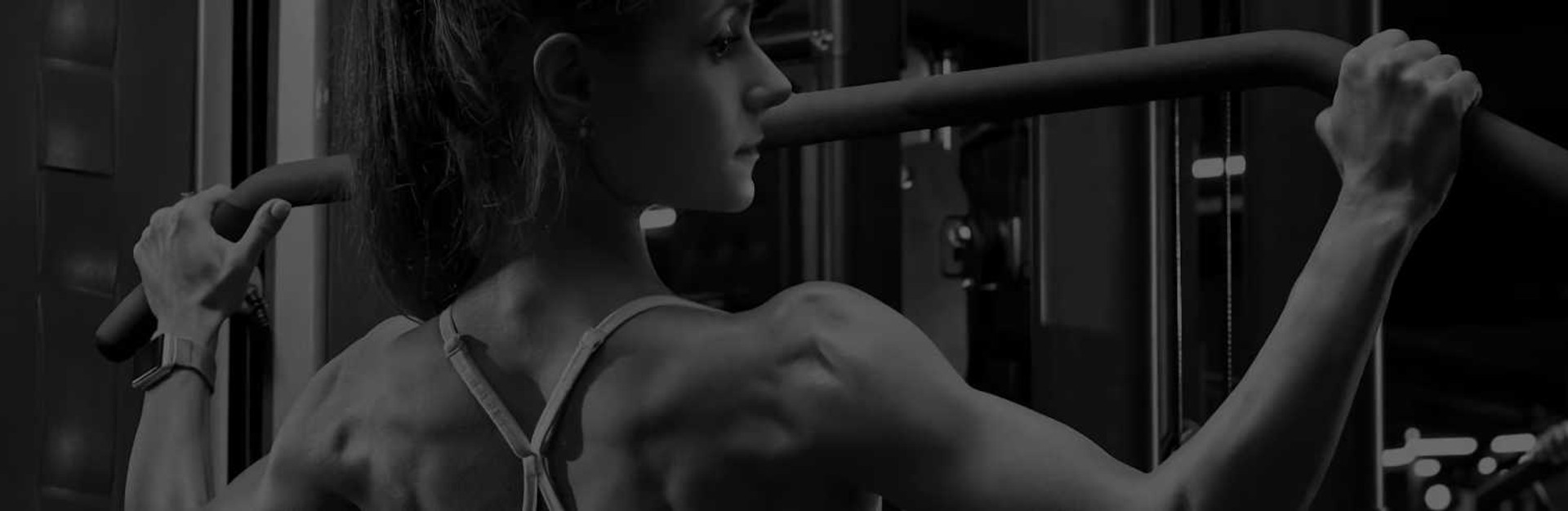 Woman Working Out on Commercial Strength Machine in Gym