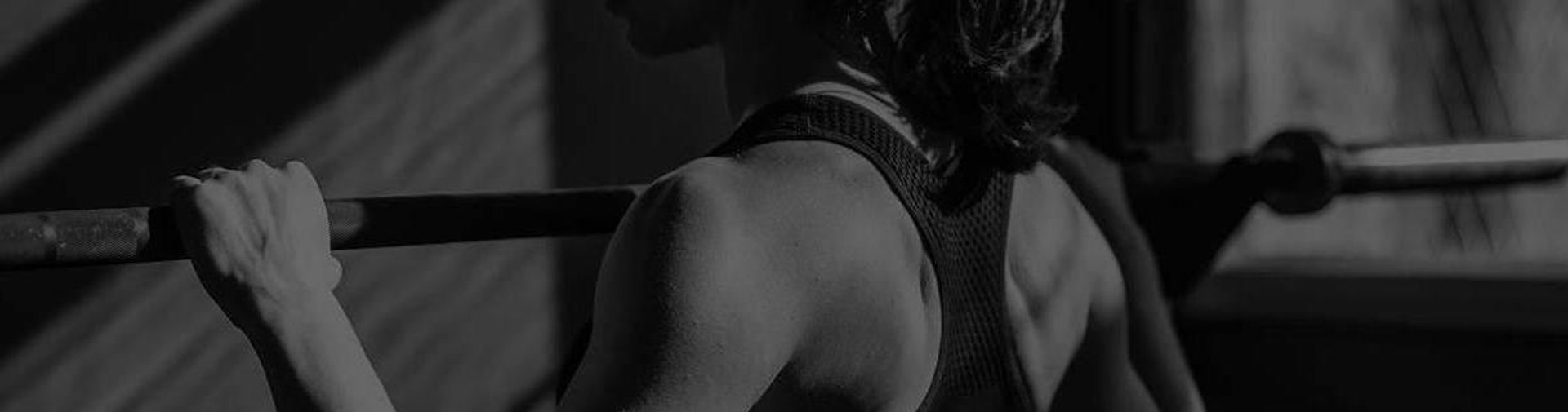 Woman Exercising on Commercial Power Rack in Gym