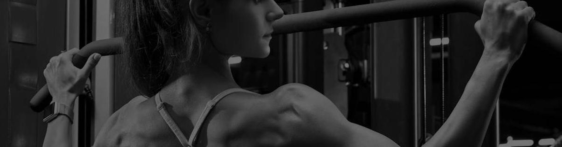 Woman Exercising on Commercial Weight Machine in Gym