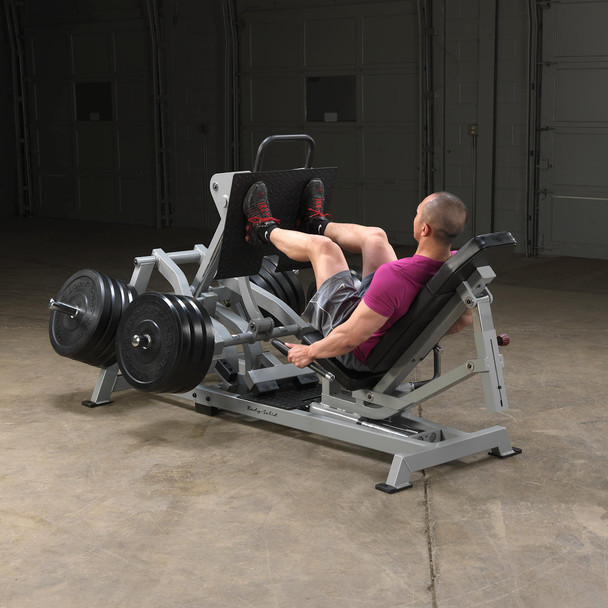 Body-Solid (LVLP) Plate-Loaded Leg Press Machine - Man Exercising in Garage Gym