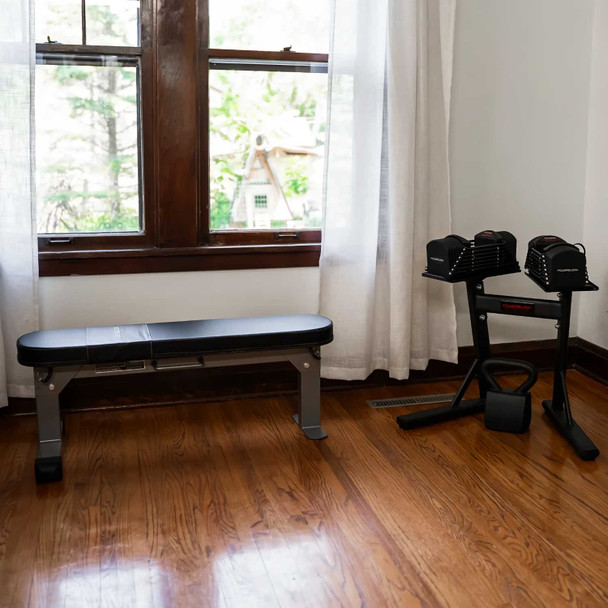 PowerBlock Portable Flat Bench with Optional Dumbbells in Fitness Room