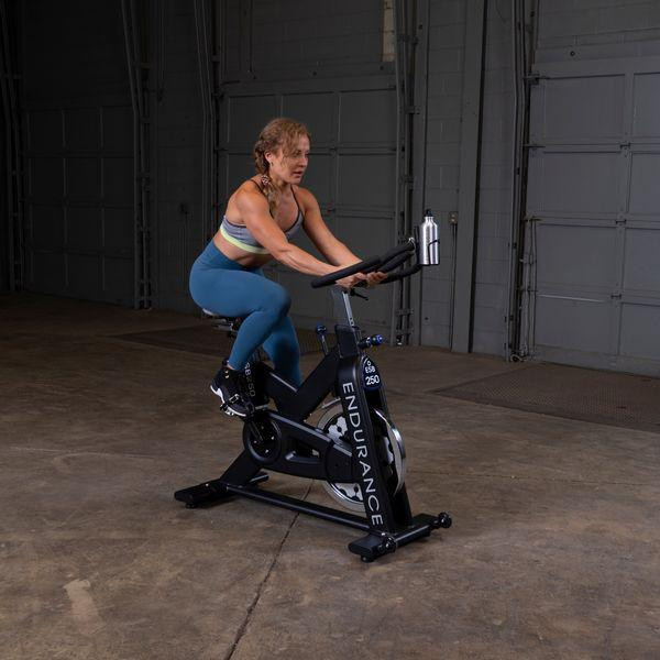 Body-Solid Endurance Indoor Cycle w/ Female User in Fitness Room