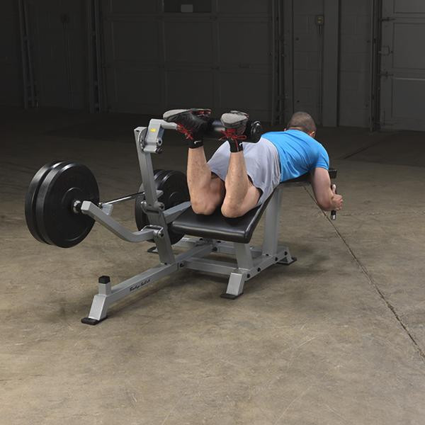 Body-Solid Plate-Loaded Leg Curl Machine - Man Exercising w/ Optional Bumper Plates