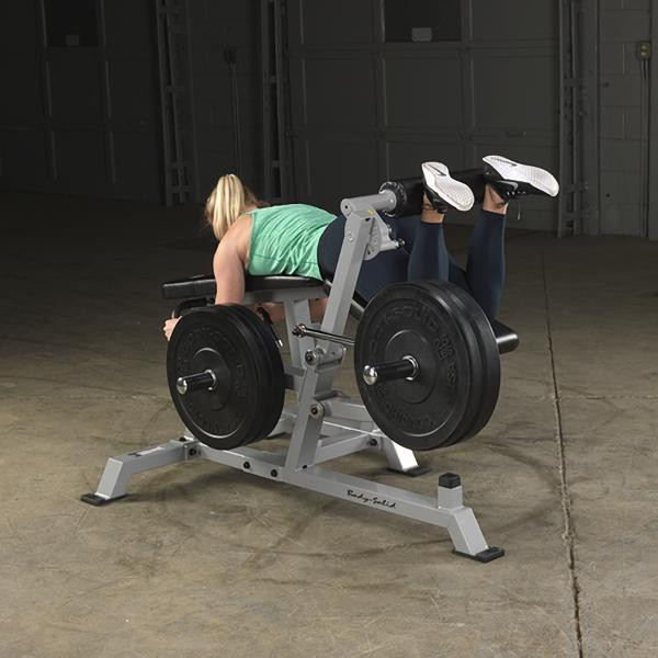 Body-Solid (LVLC) Leverage Leg Curl Machine - Woman Exercising in Prone Position