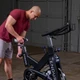 Body-Solid Studio Cycle Showing Rider Adjusting Seat Height
